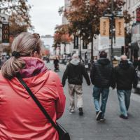 Woman in the front, people walking in Antwerp